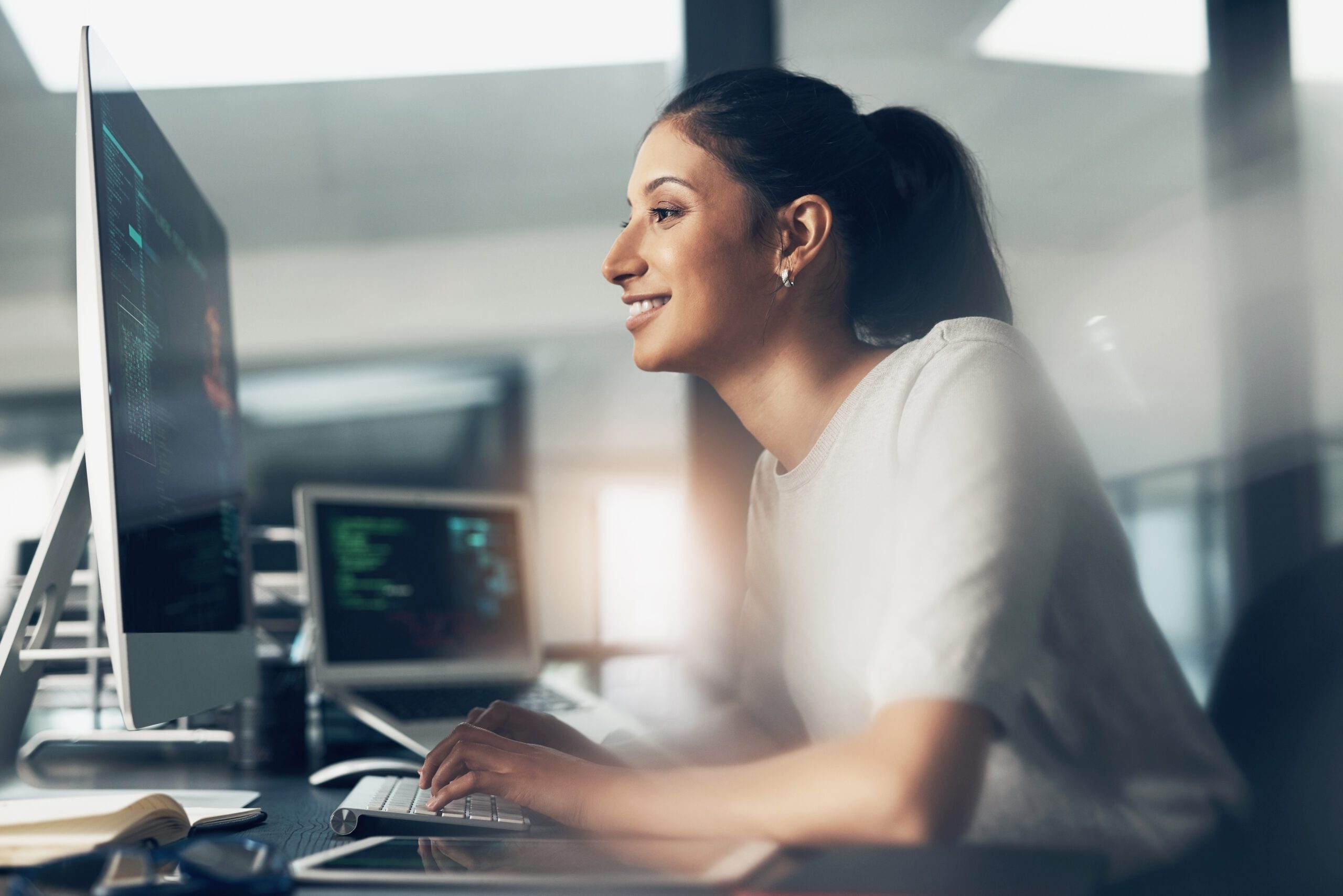 Life as a coder. Shot of a woman using a computer in a modern office.